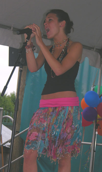 Photo of Julie Dubela singing at concert at Six Flags